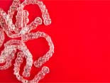 pile of clear aligners against a red background