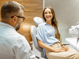 Female patient smiling at dentist at dental appointment